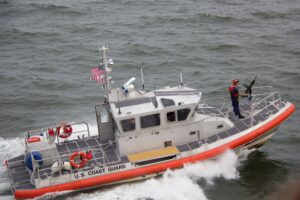 white orange u s coast guard boat on the sea