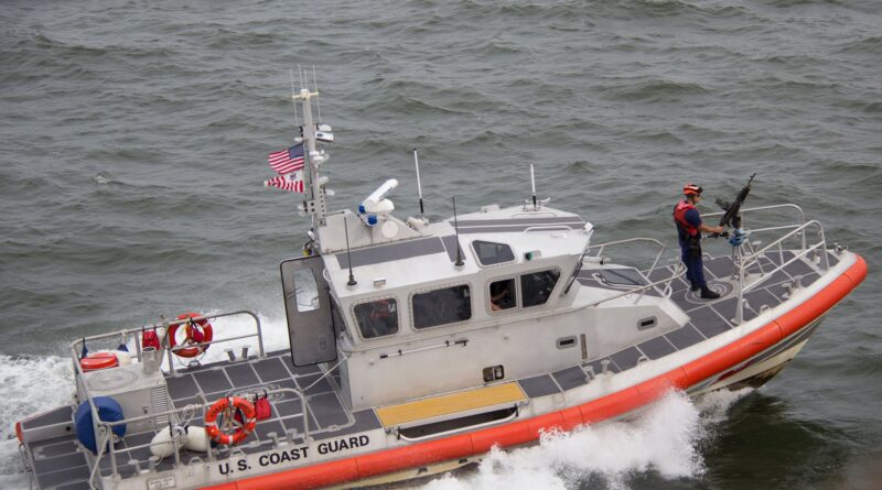 white orange u s coast guard boat on the sea